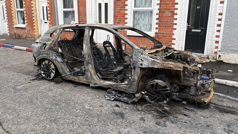 Shells of burned-out cars could be seen on Belfast's streets on Wednesday. Pic: PA