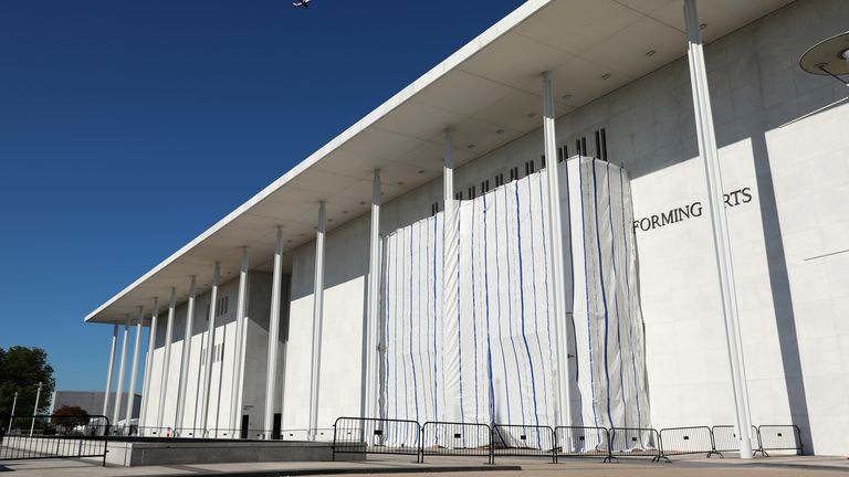 Scaffolding covers the outside of the venue, covering up Donald Trump's name. Pic: AP