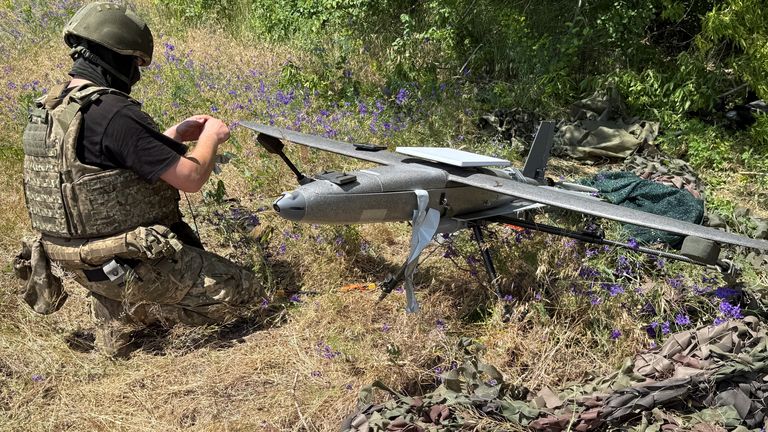 A Ukrainian serviceman prepares to launch a Hornet drone. Pic: Reuters