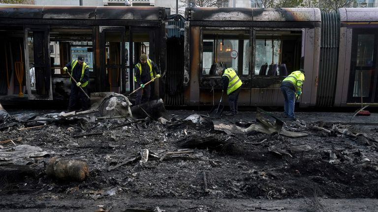 Workers cleaning up the aftermath. Pic: PA