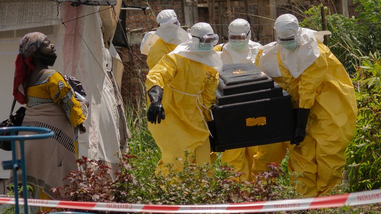 Red Cross workers carry the coffin of a person who died of Ebola. Pic: AP