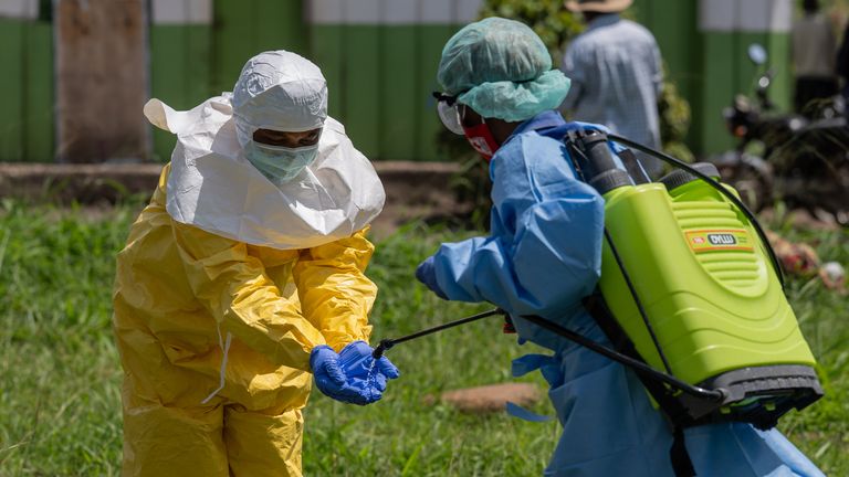A Red Cross worker disinfects after transporting bodies. Pic: AP