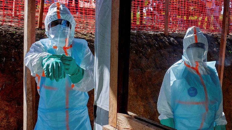 Health workers get dressed in personal protective equipment  at the Evangelical Medical Center. Pic: Reuters