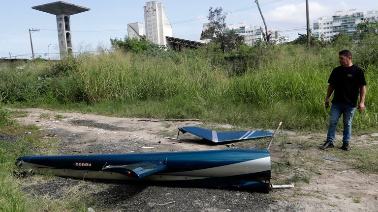 Aircraft debris lies near the site where two helicopters reportedly collided in midair in Rio de Janeiro. Pic: AP