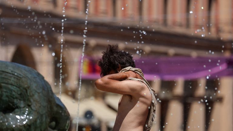 A man near the Fountain of Neptune during hot weather in Bologna, Italy. Pic: Reuters