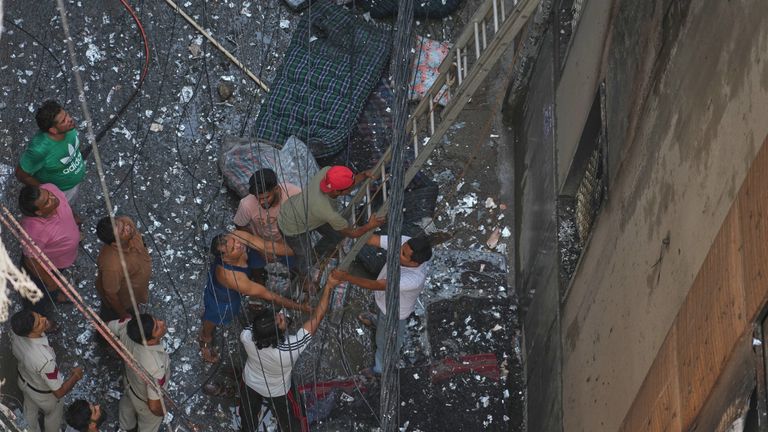 Firefighters and locals worked to help people escape the fire. Pics: AP