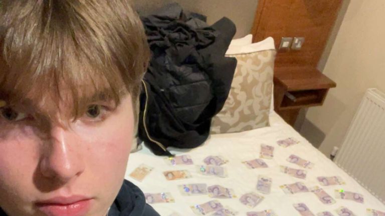 Natland takes a selfie with cash on the bed. Pic: Met Police