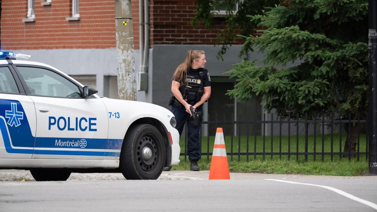 Police with weapons drawn in Montreal. Pic: AP