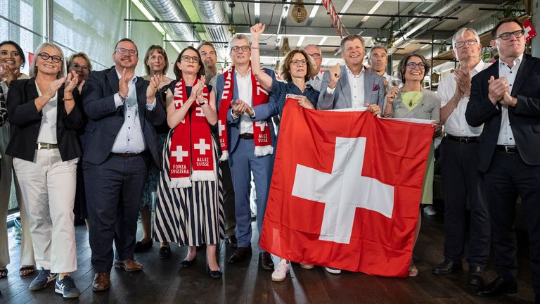 Federal Parliament members and other representatives of civic organisations celebrate the result in Bern. Pic: AP