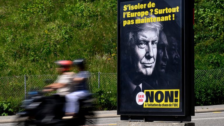 A poster as part of the 'no campaign' with Donald Trump on it stands in the streets of Lausanne. Pic: AP