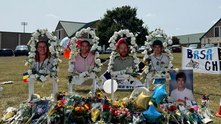 A poster with images of the shooting victims. Pic: AP