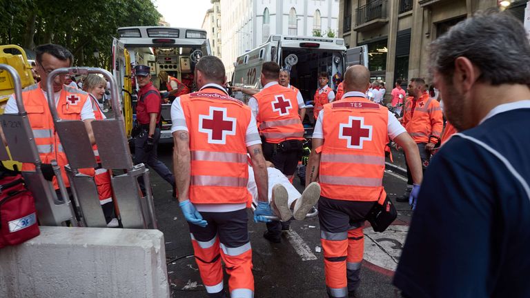 A runner is taken to an ambulance. Pic: AP