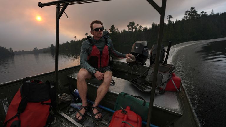 A tow boat evacuates the Boundary Waters Canoe Area Wilderness amid wildfires. Pic: Anthony Souffle/Minnesota Star Tribune via AP