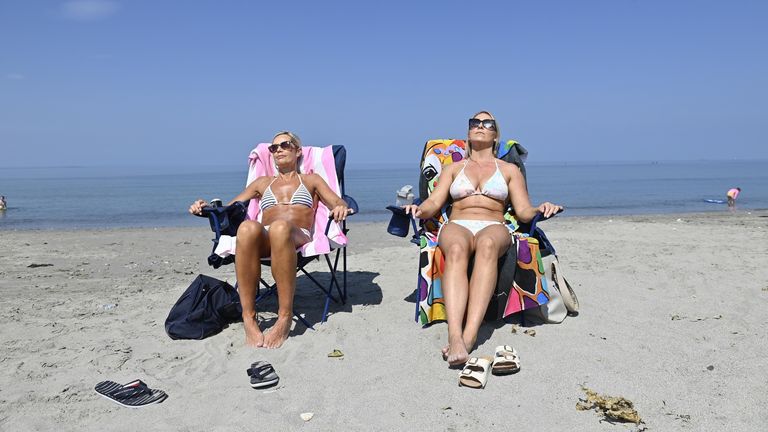 People enjoy the hot weather on the beach near Carnfunnock in Co Antrim. Pic: PA
