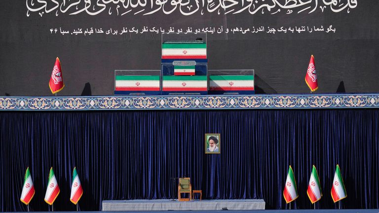 The coffins of Khamenei and his family stood on a platform above an empty chair. Pic: AP