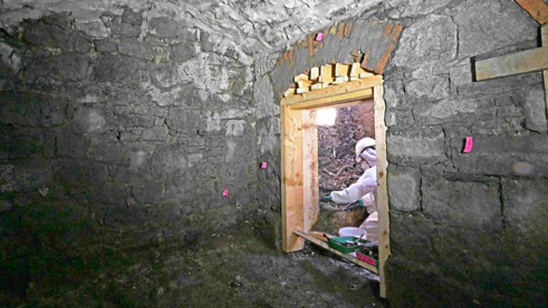 A forensic excavation team member working inside the underground vaulted structure. Pic: ODAIT

