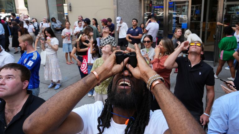 People watched the incident from the streets below. Pic: Reuters