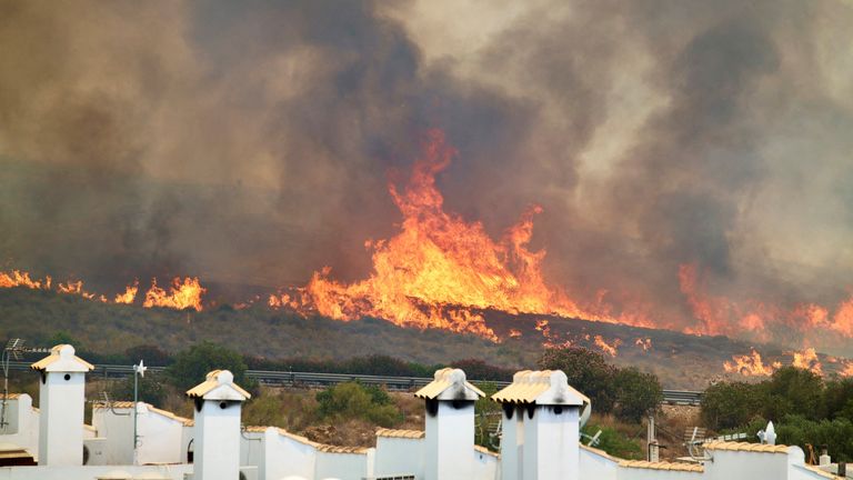 Flames approach a highway. Pic: Reuters