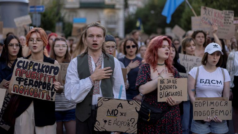 People sing the national anthem during a protest demanding the reinstatement of Mykhailo Fedorov. Pic: Reuters