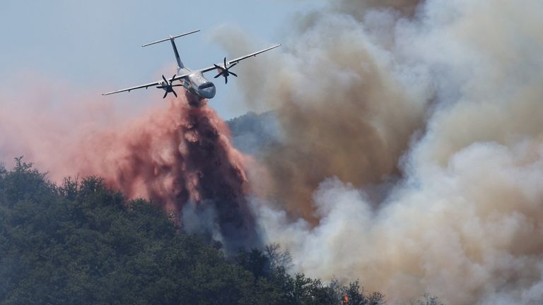 A plane takes part in the effort to tackle a wildfire in Perpignan.  Pic: Reuters