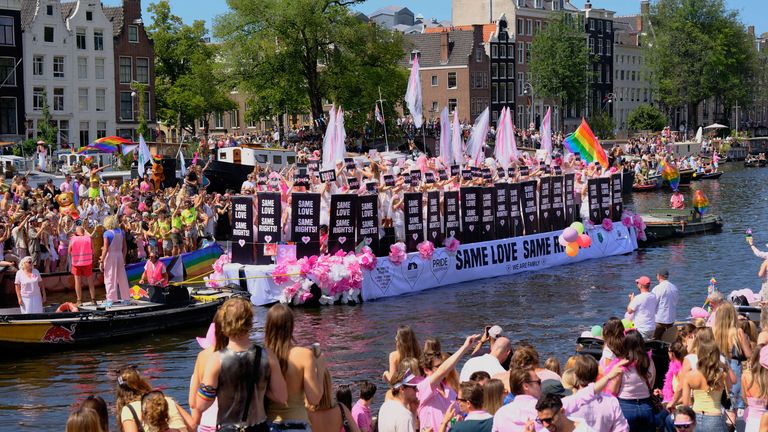 People lined Amsterdam's canals to watch the parade there. Pic: AP