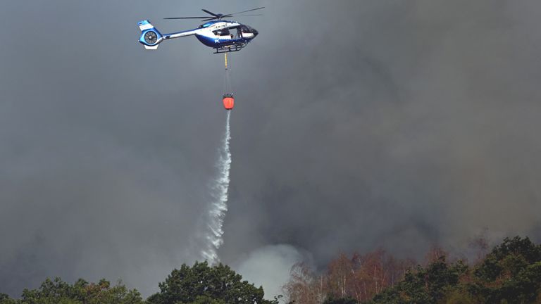 A police helicopter assists with firefighting efforts in Germany. Pic: AP