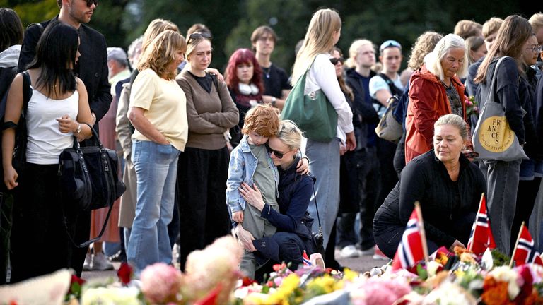 People gather to pay their respects outside the Royal Palace.
Pic: Reuters