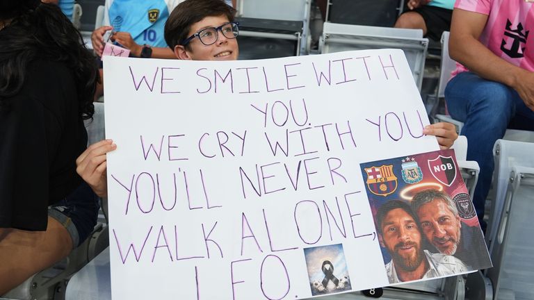 A fan holds a sign in memory of Lionel Messi's father on the day he died during an Inter Miami MLS match in Miami. Pic: AP