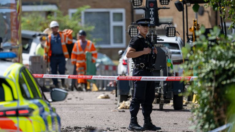 Police and gas workers at the scene of the blast. Pic: SWNS  qhxidiqxkirkinv