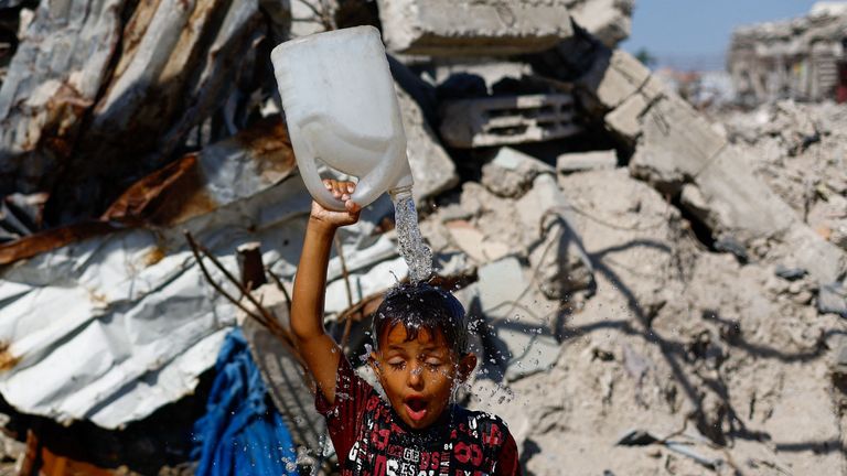 A Palestinian boy cools off at the Jabalia refugee camp in the northern Gaza Strip. Pic: Reuters
