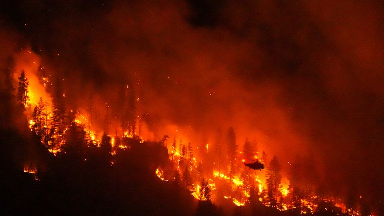 A wildfire burns on the west side of Okanagan Lake, British Columbia, on Monday. Pic: AP