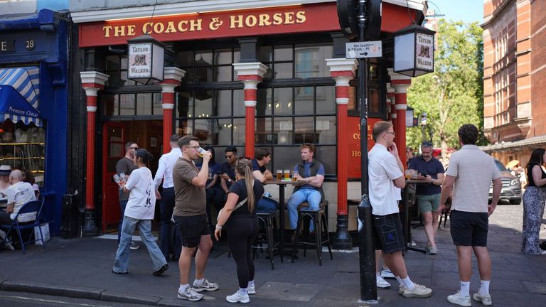 People drinking outside The Coach & Horses pub in Soho, central London. Pic: PA