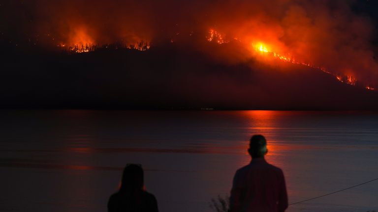 A wildfire burns on the west side of Okanagan Lake, British Columbia, on Monday. Pic: AP