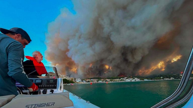 People take shelter on a boat off the coast of Greece. Pic: Reuters
