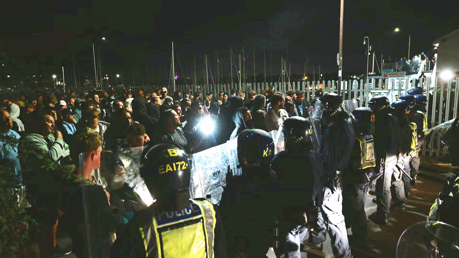 Officers injured and vehicles damaged during anti-migrant protest - as police hunt suspects
