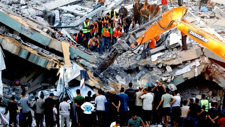 Civil defence workers attempt to rescue people trapped beneath the rubble. Pic: Reuters