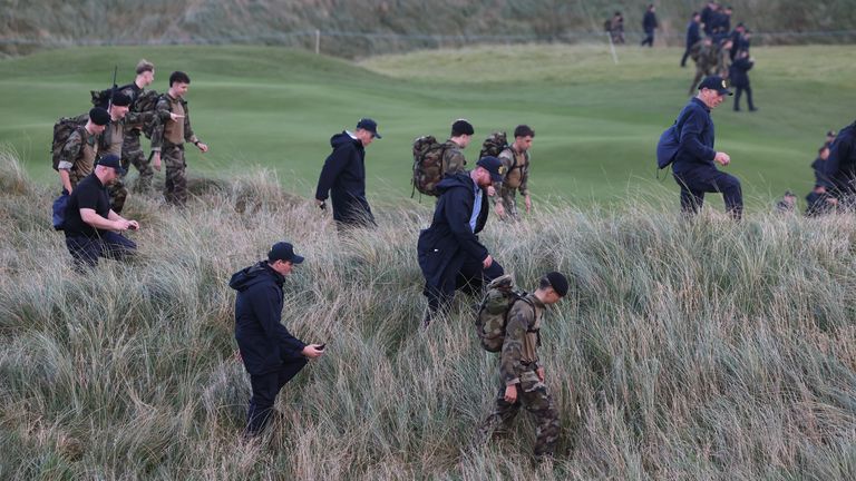 Garda officers and members of the Irish Defence Force conduct a security sweep at Trump International Golf Links Ireland. Pic: PA