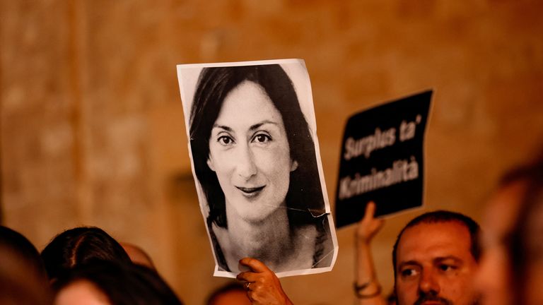 A portrait of investigative journalist Daphne Caruana Galizia is held up during a protest on Wednesday night. Pic: Reuters