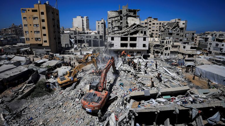 Heavy machinery is used to try rescue those who are trapped in rubble from a building that collapsed in Gaza. Pic: Reuters