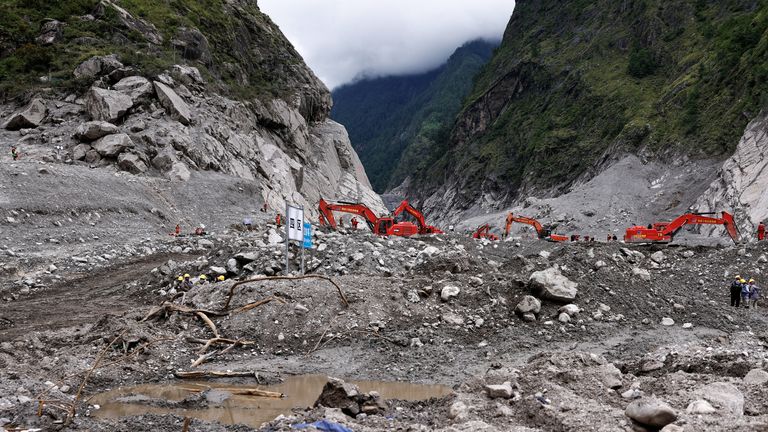 Rescue workers aided by diggers at Gyirong Port. Pic: Reuters