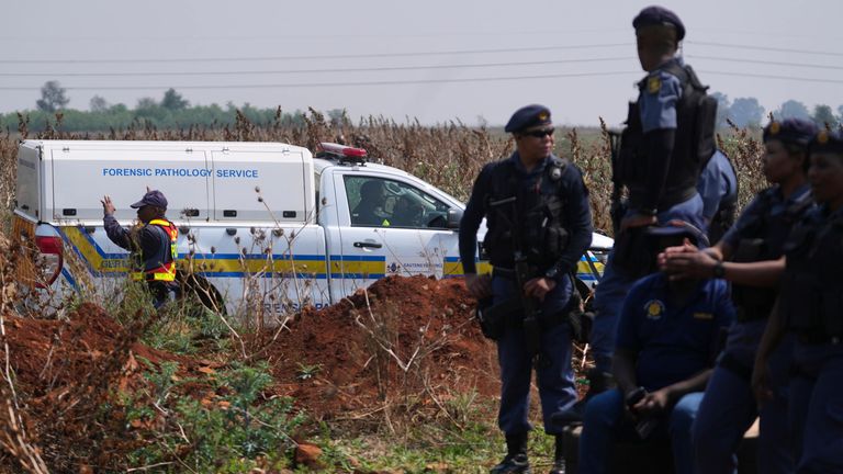 Forensic investigators work at the site where the body of a woman was found. Pic: AP