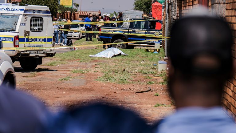 A body, believed to be that of a woman, is found along a road in KwaThema. Pic: AP
