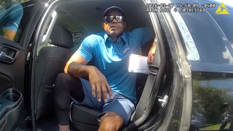 Tiger Woods sits in an unmarked police car following a car crash in March. Pic: Martin County Sheriff's Office via AP