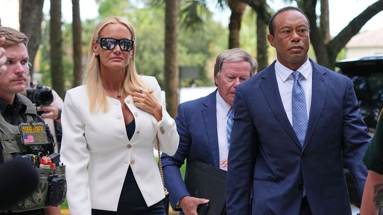 Golfer Tiger Woods, second from right, arrives at court with Vanessa Trump, left. Pic: AP