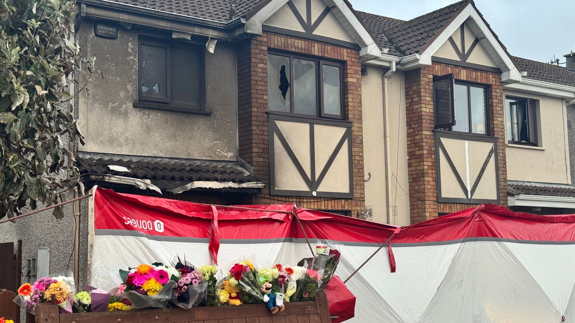 Flowers are left outside the Waterford home. Pic: PA