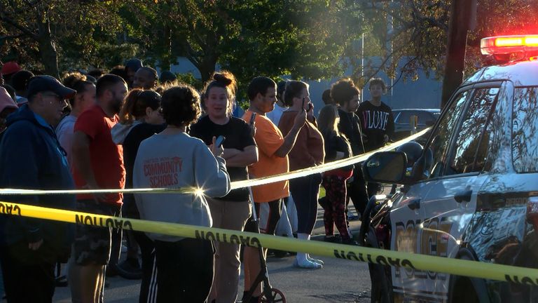 Residents gathered near the crime scene in Erie. Pic: WJET via AP